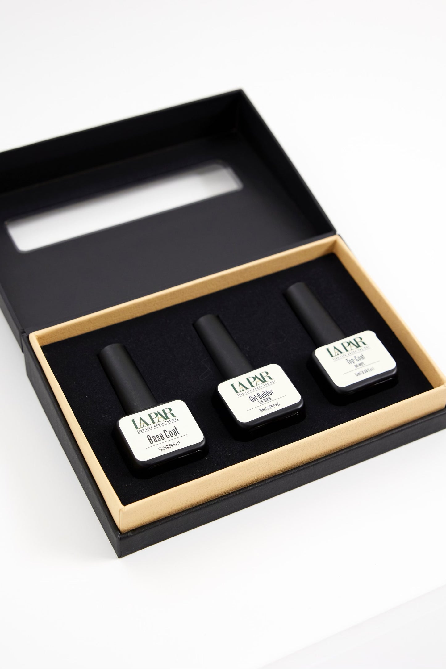 Open box of La Par Foundation Trio Kit featuring Base Coat, Gel Builder and Top Coat at an angle
